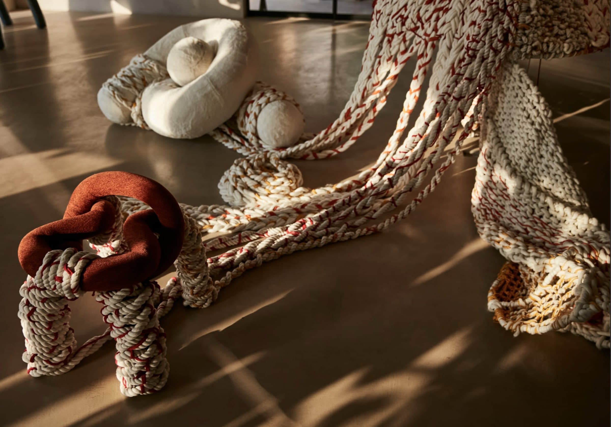 A hand-braided wool and cotton installation catching low afternoon light